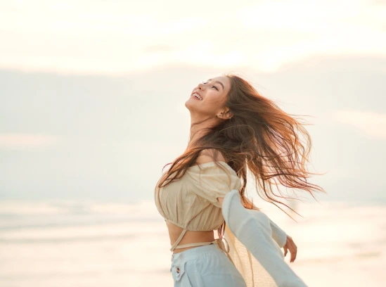 A happy girl by the sea.